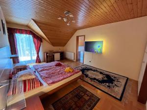 a bedroom with a large bed and a wooden ceiling at Klára Villa in Balatonboglár