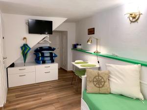 a bedroom with a bed and a desk and a sink at Apartments Padre **** in Baška