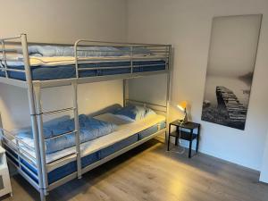 two bunk beds in a room with a lamp at Emda Country living close to Legoland in Billund