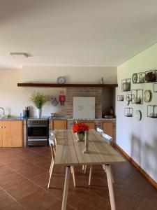 a kitchen with a wooden table with flowers on it at Casa Vilarelho in Caminha
