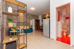 a living room with a blue couch and a kitchen at Apartment Feel the nature in Slime