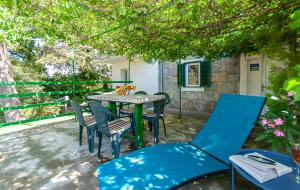 a patio with a table and chairs under a tree at Apartment Feel the nature in Slime