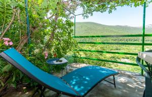 a slide and a chair on a porch with a view at Apartment Feel the nature in Slime