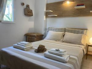 a bedroom with a bed with towels on it at Es Pujols Vista Mare in Es Pujols