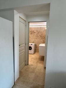 a bathroom with a washer and dryer in a room at La maison du Soleil in Porticcio +8 photos