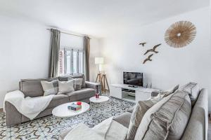 a living room with two couches and a tv at Villa Monsy 2 in El Port