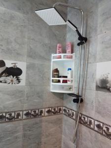 a shower in a bathroom with a shower head at Bel appartement quartier Bourgogne in Casablanca