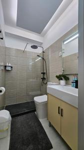 a bathroom with a sink and a toilet and a mirror at Papagayo Beach Apartments in Arona