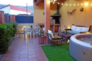 a patio with a table and chairs and a fireplace at Casas Rurales Florentino in Robledillo