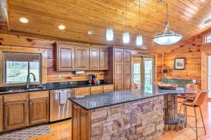 cocina con armarios de madera y encimera de piedra en 22-Acre Home on Bourbon Trail with Sunroom!, en Coxs Creek