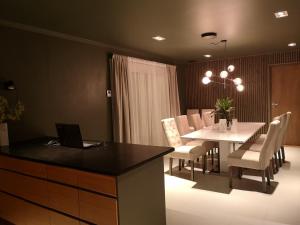 a dining room with a table and a laptop on it at Homestay Storesund in Storasund