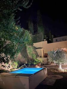a swimming pool in the middle of a yard at night at La Casa di Nada Home in Tavarnelle in Val di Pesa