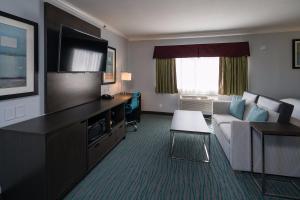 a hotel room with a couch and a television at Inn On Grove in San Francisco