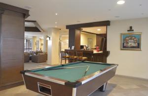 a pool table in the middle of a living room at Winslow Infinity Aparthotel in Bansko