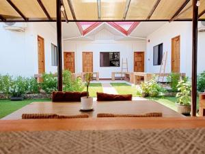 a dining table in a living room with a view of a yard at CASA MIA INN Bed and breakfast in Dauis