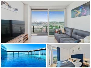 维也纳Luxury Penthouse I Rooftop Pool I Self Check-in的带沙发和大窗户的客厅