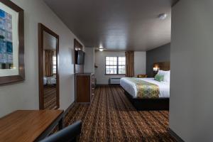 a hotel room with a bed and a table at Extended Stay Airport in Green Bay
