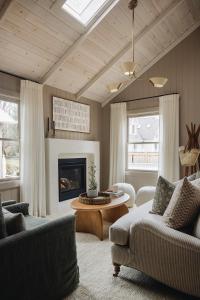 a living room with a couch and a fireplace at Townie 3 - The Moss in Union Pier