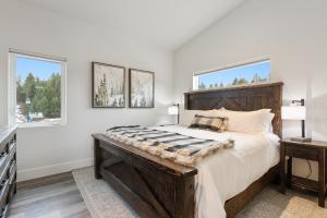 a bedroom with a large bed and two windows at Quarry B10 in Whitefish +26 photos
