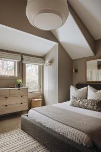 a bedroom with a large bed and a window at The Townie Cottages - All Units in Union Pier
