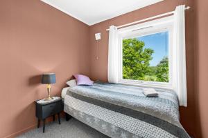 a bedroom with a bed and a window at Engbu in Vågbø