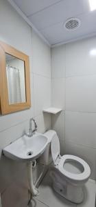 a white bathroom with a toilet and a sink at Pousada Hostel Mar e Sertão in Maceió +28 photos