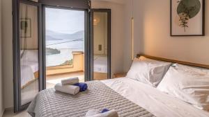 a bedroom with a large bed with towels on it at Adaman Villas in Meganisi +105 photos