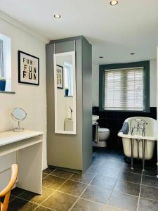 Un baño con bañera, inodoro y lavabo. en Inglenook of Deal, en Kent