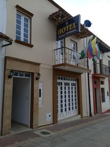 a hotel with a sign on the side of a building at Hotel Colonial El Bosque in Tunja