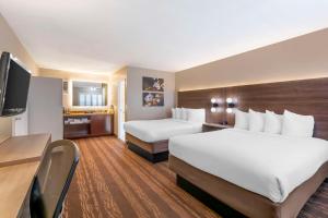 a hotel room with two beds and a flat screen tv at Best Western Plus Stovall's Inn in Anaheim +46 photos