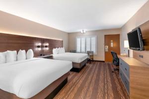 Habitación de hotel con 2 camas y TV de pantalla plana. en Best Western Plus Stovall's Inn en Anaheim