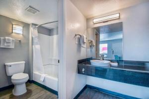 a bathroom with a toilet and a sink and a mirror at Motel 6-Albuquerque, NM - Carlisle in Albuquerque +37 photos