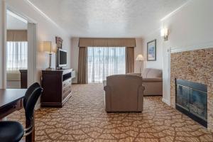 a hotel room with a living room with a couch and a television at Best Western Salinas Monterey in Salinas
