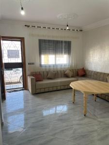 a living room with a couch and a table at Rhach alhoceima in Al Hoceïma