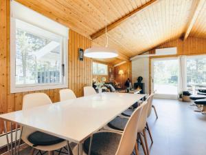 a dining room with a large white table and chairs at Holiday home Strandby XIII in Strandby