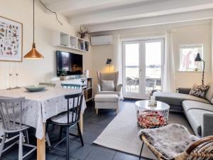 a living room with a table and a couch at 6 person holiday home in Hadsund-By Traum in Hadsund