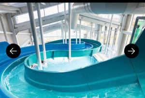 a water slide in a building with two arrows pointing up at The Lay By in Prestonpans