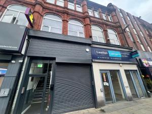 a store front of a building on a street at Flat 2 - Luxury Bolton City Centre Apartments in Bolton