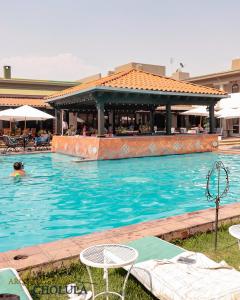 a pool with a person in the water at Villas Arqueologicas Cholula in Cholula