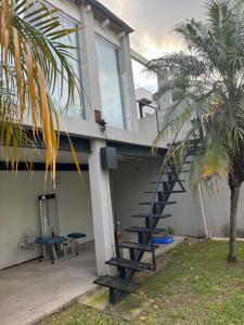 a house with a staircase on the side of it at Casa Premium Habitaciones in Buenos Aires
