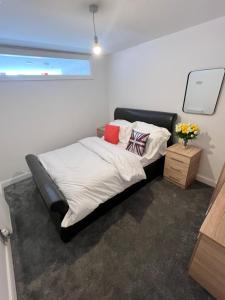 a bed in a room with a black bed frame at Flat 2 - Luxury Bolton City Centre Apartments in Bolton