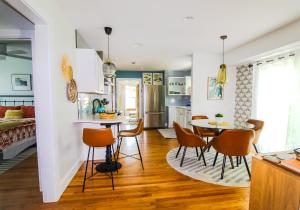 a kitchen and living room with a table and chairs at Luxurious Bohemian Bungalow in Lincolnville - Mins from Downtown! in St. Augustine