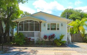 a small white house with a fence at Luxurious Bohemian Bungalow in Lincolnville - Mins from Downtown! in Saint Augustine