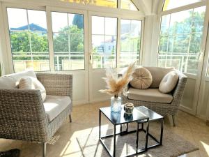 a living room with two chairs and a table at Avalena Rooms in Zadar