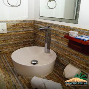 a bathroom with a sink and a mirror at Hotel Pancho Villas Bacalar - Gratis Renta Kayyaks in Bacalar