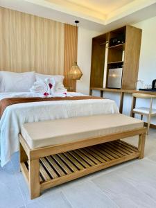 Siargao Island Villas في جنرال لونا: غرفة نوم بسرير كبير مع طاولة