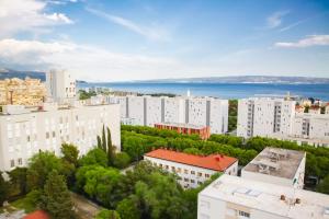 an aerial view of a city with buildings and the ocean at The Golden View Apartment in Split