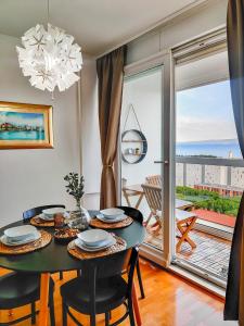 a dining room with a table and a large window at The Golden View Apartment in Split