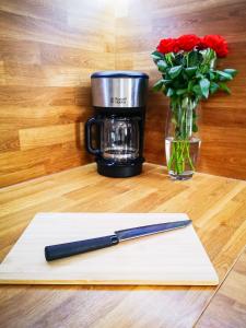 a knife sitting on a cutting board next to a coffee mug at The Golden View Apartment in Split