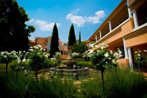 a garden with a fountain in the middle of a building at Little Tuscany Boutique Hotel in Johannesburg